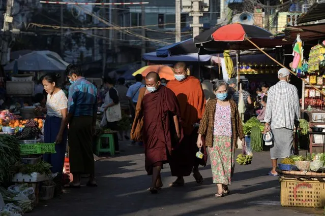 People walk at a market after army seized power in a coup in Yangon, Myanmar, February 2, 2021. (Photo by Reuters/Stringer)