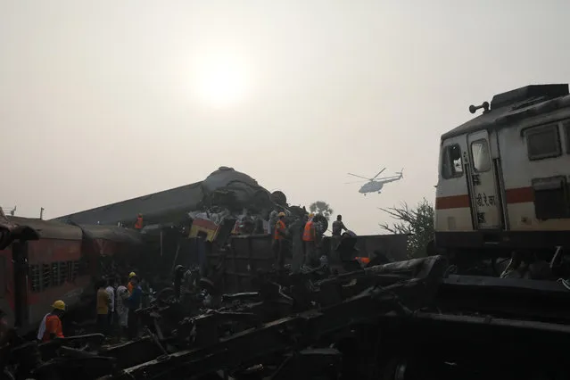 A helicoter flys over the site as the National Disaster Response Force Rescue continues work at the site of a train accident at Odisha Balasore, India, 03 June 2023. Over 200 people died and more than 900 were injured after three trains collided one after another. According to railway officials the Coromandel Express, which operates between Kolkata and Chennai, crashed into the Howrah Superfast Express. (Photo by Piyal Adhikary/EPA/EFE/Rex Features/Shutterstock)