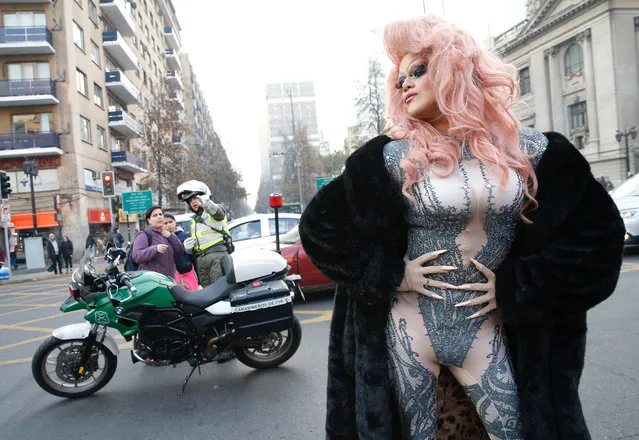 A participant performs during a gay pride parade to demand for a new law for gender equality, according to organisers, in Santiago, Chile June 23, 2018. (Photo by Rodrigo Garrido/Reuters)