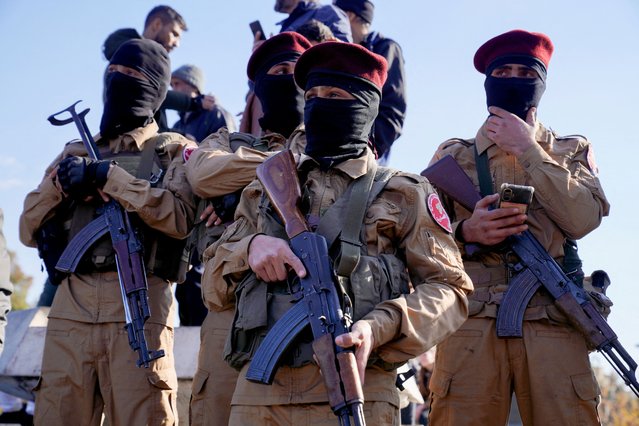 Members of the Syrian National Army which is backed by Turkey hold weapons, after fighters of the ruling Syrian body ousted Bashar al-Assad, in Aleppo, Syria on December 13, 2024. (Photo by Karam al-Masri/Reuters)
