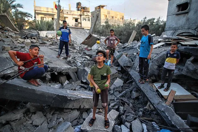 Palestinian children stand amid the rubble of their destroyed family home following Israeli strikes on the town of Beit Lahiya, in the northern Gaza Strip on May 30, 2023. Israel and the Islamic Jihad movement agreed to an Egyptian-brokered truce in late May 13. Israel carried out several attacks against the military leadership of the Palestinian Islamic Jihad Movement, in response to the firing of rockets towards Israel from the Gaza Strip. (Photo by Habboub Ramez/ABACA Press/Rex Features/Shutterstock)