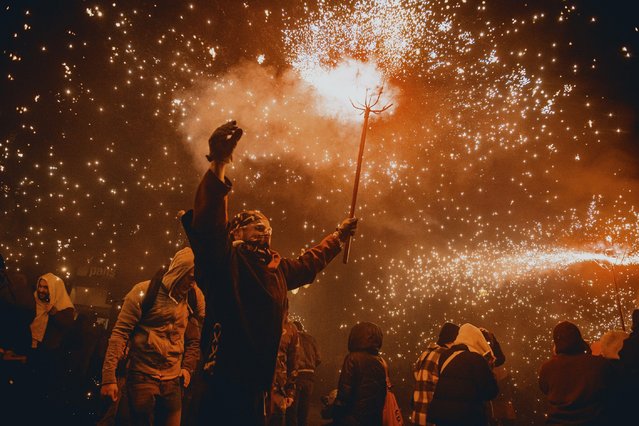 A fire runner in a devil costume dance to traditional drums under fireworks during the “Correfocs” (fire-runs) at Barcelona's winter city festival “Santa Eulalia” on February 8, 2025. (Photo by Matthias Oesterle/Alamy Live News)