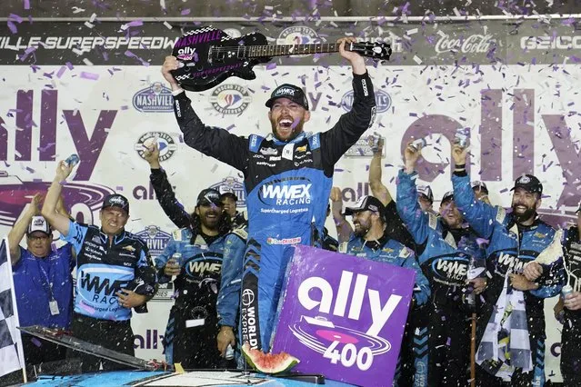 Ross Chastain holds a guitar presented to him after winning a NASCAR Cup Series auto race, Sunday, June 25, 2023, in Lebanon, Tenn. (Photo by George Walker IV/AP Photo)