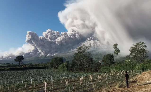 Mount Sinabung spews volcanic materials during an eruption in Karo, North Sumatra, Indonesia, 02 March 2021. The volcano erupted on 02 March, spewing volcanic materials 5,000 meters up in the air. (Photo by Sastrawan Ginting/EPA/EFE)