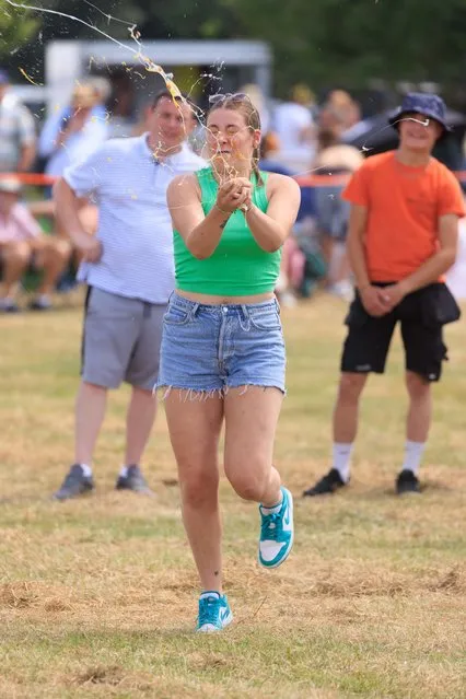 The World Egg Throwing Championships 2023 being held near the village of Swaton, Lincolnshire in United Kingdom on June 25, 2023. The organised sport of Egg Throwing is thought to date back to at least 1322 when the newly appointed Abbot took possession of the Parish of Swaton by royal decree. It is said that he was the only person to own chickens and ensured the attendance at church of his peasant by providing them alms of one egg for each attendee. However, when the River Eau flooded, preventing people getting to church, the monks would hurl the eggs over to the waiting peasants. (Photo by Tim Scrivener/Bournemouth News)