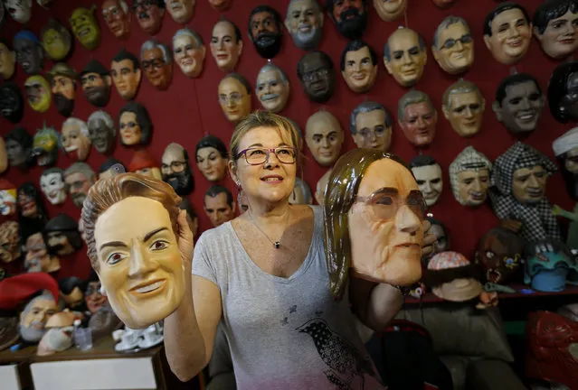 Olga Valles shows carnival masks in the likeness of former  Petrobras' CEO Maria das Gracas Foster, right, and Brazil's President Dilma Rousseff at the Condal factory in Rio de Janeiro, Brazil, Friday, February 6, 2015. Brazil's state oil company is in crisis amid an expanding corruption investigation into a long-running kickback scheme on its contracts, forcing the resignation of das Gracas Foster and making her mask a popular item. (Photo by Silvia Izquierdo/AP Photo)