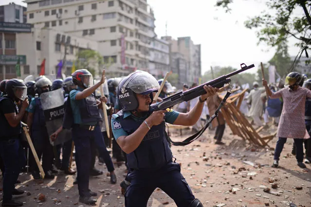 Security officers disperse demonstrators protesting against the visit of Indian Prime Minister Narendra Modi after Friday prayers at Baitul Mokarram mosque in Dhaka, Bangladesh, Friday, March 26, 2021. (Photo by Mahmud Hossain Opu/AP Photo)