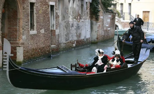 Masked revellers ride a gondola during the Venice Carnival, February 7, 2015. (Photo by Stefano Rellandini/Reuters)