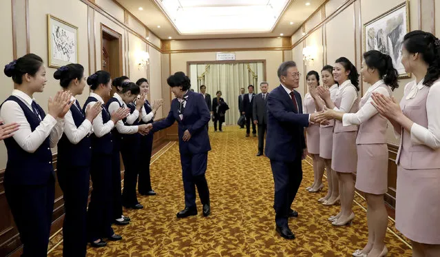 South Korean President Moon Jae-in, center right, and his wife Kim Jung-sook, shake hands with staff of Paekhwawon State Guesthouse before leaving for the Mount Paektu, in Pyongyang, North Korea, Thursday, September 20, 2018. (Photo by Pyongyang Press Corps Pool via AP Photo)