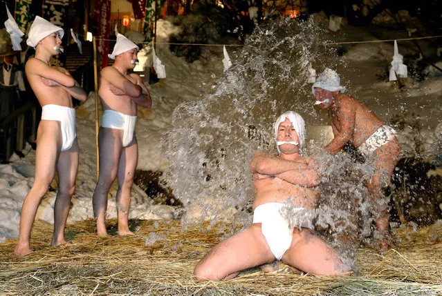 One of four 'Gyoshusha' young men wearing loincloths kneels while poured ice cold water to purify body and soul during the 'Kanchu Misogi' mid winter purification ritual festival in minus 2.9 degrees Celsius temperature at the Samegawa Jinja Shrine on January 13, 2016 in Kikonai, Hokkaido, Japan. The ritual in Kikonai city is thought to be the Japan's northernmost of its kinds started in 1831, continues until Janaury 15. (Photo by The Asahi Shimbun via Getty Images)