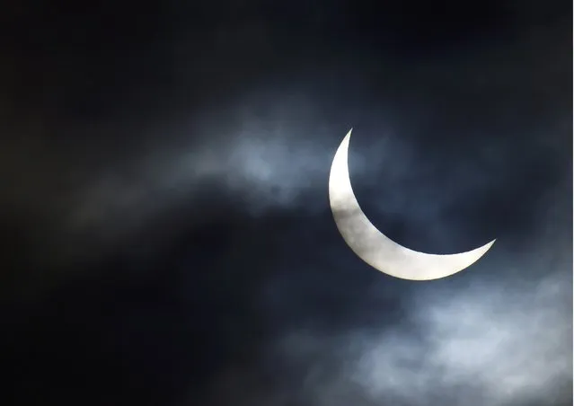 A partial solar eclipse is seen from near Bridgwater, in south western England, March 20, 2015. (Photo by Toby Melville/Reuters)