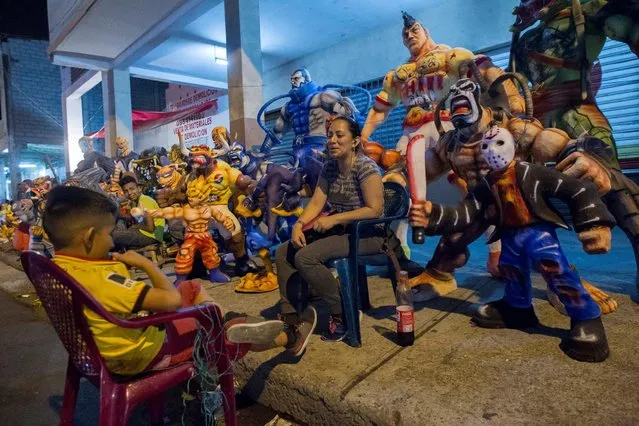 People sell effigies on the street, which will be burnt on New Year's Eve, in Guayaquil, Ecuador December 23, 2016. (Photo by Guillermo Granja/Reuters)