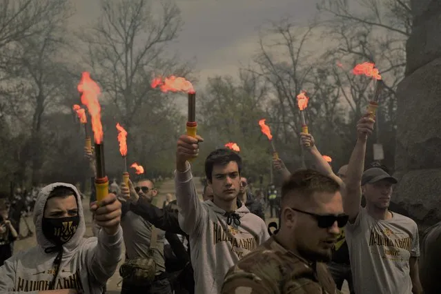 Members of nationalist movements attend a rally to commemorate the seven-year anniversary of deadly clashes which killed dozens of demonstrators in Odessa, Ukraine, Sunday, May 2, 2021. A total of 48 people died in the 2014 clashes between Ukraine's government supporters and pro-Russia protesters in the Ukrainian city of Odessa, including dozens in a burning building. (Photo by Felipe Dana/AP Photo)