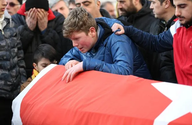 Relatives and friends mourn at a coffin during the funeral of Ayhan Arik, one of the 39 victims of the gun attack on the Reina, a popular night club in Istanbul near by the Bosphorus shores, in Istanbul, January 1, 2017, Turkey. According to Turkey's interior minister Suleyman Soylu at least 39 people, including at least 15 foreigners have been killed dead and 40 wounded at terror attack at Istanbul's famous night club of Reina in Bosphorus shores in the new year party. (Photo by Burak Kara/Getty Images)