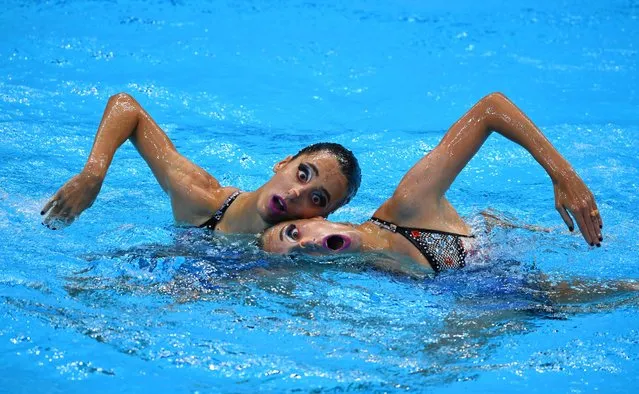 Austria's Anna-Maria Alexandri and Austria's Eirini Alexandri compete in the preliminary for the women's duet free artistic swimming event during the Tokyo 2020 Olympic Games at the Tokyo Aquatics Centre in Tokyo on August 2, 2021. (Photo by Clodagh Kilcoyne/Reuters)