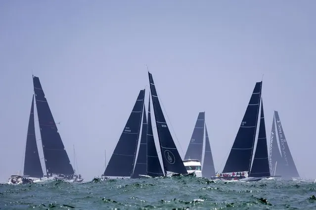 Sail boats enter open water after the start of the Sydney Hobart yacht race in Sydney, Tuesday, December 26, 2023. The 630-nautical mile race has more than 100 yachts starting in the race to the island state of Tasmania. (Photo by Salty Dog/CYCA via AP Photo)