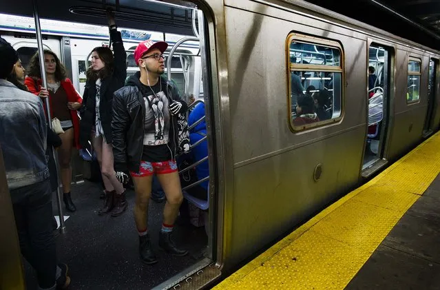 People stand aboard a departing subway train in New York. (Photo by Craig Ruttle/Associated Press)