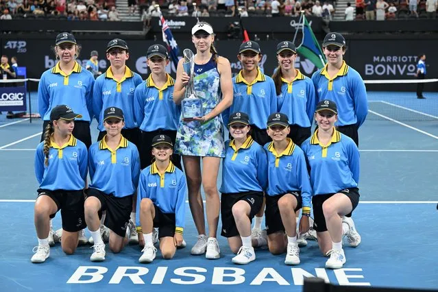 Elena Rybakina of Kazakhstan poses with the trophy flanked by ball kids after winning the women's final of the 2024 Brisbane International against Aryna Sabalenka of Belarus, at Queensland Tennis Centre in Brisbane, Australia 07 January 2024. (Photo by Darren England/EPA)