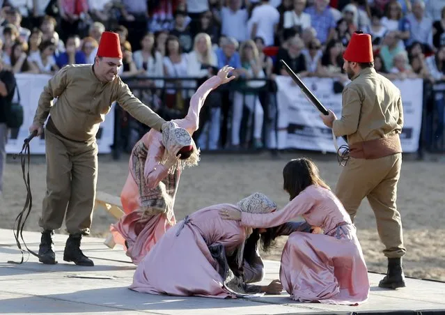 Performers reenact the capture of Armenians during a commemoration marking the 100th anniversary of the mass killing of Armenians by OttomanTurks, in Buenos Aires, April 25, 2015. Armenia says the massacres during World War One constitute genocide, a term also used by Pope Francis, the European parliament and some two dozen nations. (Photo by Enrique Marcarian/Reuters)
