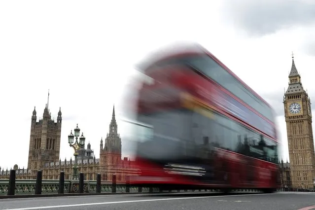 A bus drives past the Elizabeth Tower, commonly known by the name of the clock's bell, “Big Ben”, at the Palace of Westminster, home to the Houses of Parliament, in central London, on January 8, 2024. (Photo by Adrian Dennis/AFP Photo)