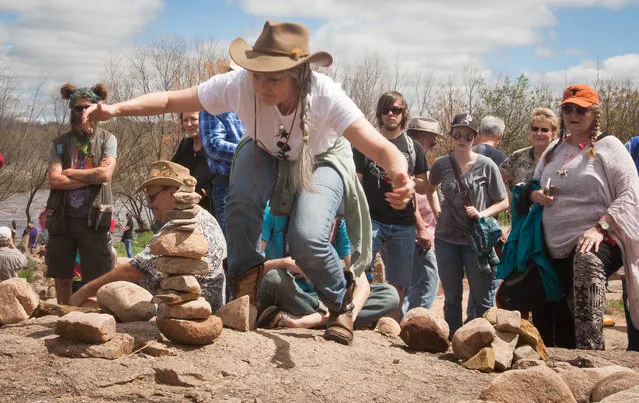 Tamra Bolton pulls back and waits to see if her rock stack is balanced during the balance competition of the festival in Llano Saturday march 12, 2016. The LEAF festival boast the Rock Stacking Championship of the World. (Photo by Nell Carroll/American-Statesman)
