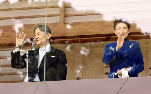 Japanese Emperor Naruhito and Empress Masako wave to well-wishers on the balcony of the Imperial Palace in Tokyo, Japan on February 23, 2024. (Photo by Yoshikazu Tsuno/Pool via Reuters)