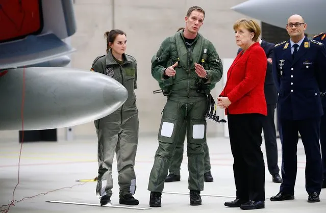 German Chancellor Angela Merkel talks to soldiers as she stands next to an Eurofighter jet during her visit at the German Luftwaffe airbase “Air Force wing 31” in Noervenich near Cologne, Germany, March 21, 2016. (Photo by Wolfgang Rattay/Reuters)