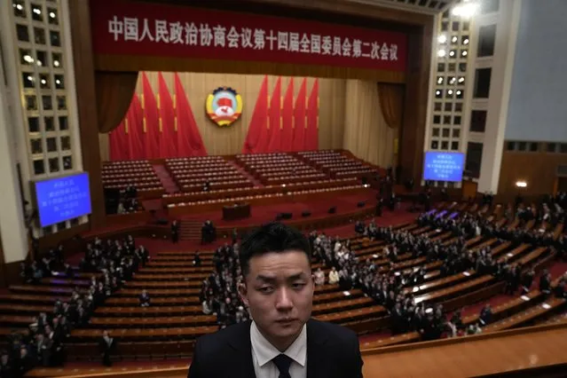 A security person looks on as delegates leave after the opening session of the Chinese People's Political Consultative Conference held the Great Hall of the People in Beijing, Monday, March 4, 2024. (Photo by Ng Han Guan/AP Photo)