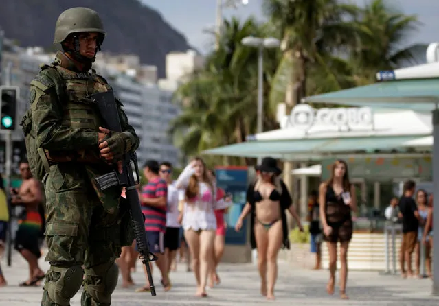 A Brazilian navy soldier patrols the Copacabana Beach before carnival festivities in Rio de Janeiro, Brazil February 14, 2017. (Photo by Sergio Moraes/Reuters)