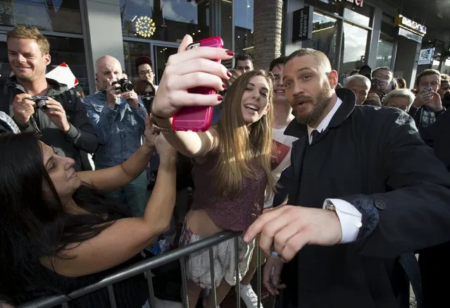 Cast member Tom Hardy poses with a fan at the premiere of “Mad Max: Fury Road” in Hollywood, California May 7, 2015. (Photo by Mario Anzuoni/Reuters)