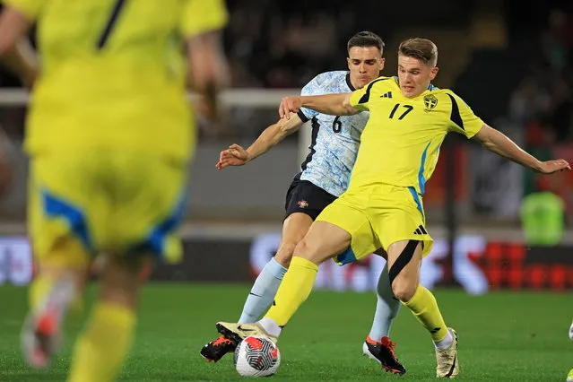 Portugal's Joao Palhinha (L) in action against Sweden's Viktor Gyokeres during an international friendly soccer match between Portugal and Sweden, in Guimaraes, Portugal, 21 March 2024. (Photo by Estela Silva/EPA)