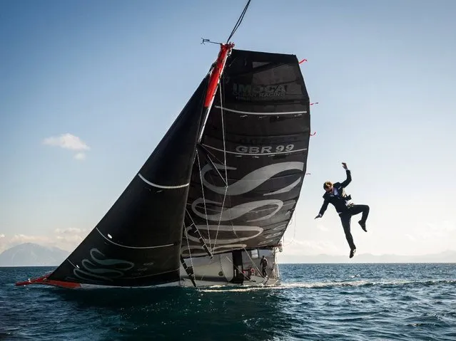 British sailor Alex Thomson performs a stunt involving jumping from his boat. (Photo by Hugo Boss)