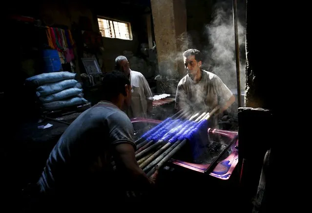 Mohamed Mostafa, 35, and Hisham Aly, 37, work at a dye workshop in old Cairo, Egypt, March 17, 2016. (Photo by Amr Abdallah Dalsh/Reuters)