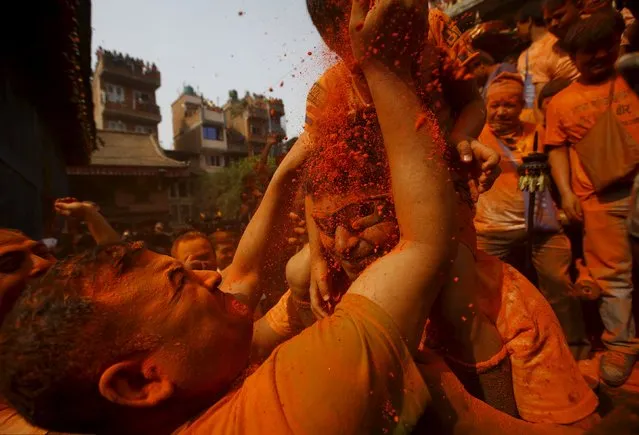 A devotee is covered with vermillion powder while celebrating the “Sindoor Jatra” vermillion powder festival at Thimi, in Bhaktapur, Nepal, April 14, 2016. (Photo by Navesh Chitrakar/Reuters)
