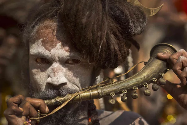 An Indian Sadhu, or Hindu holy man, plays a traditional musical instrument at the Kamakhya Hindu temple ahead of the Ambubachi festival in Gauhati, India, Friday, June 21, 2019. The festival is held in celebration of the annual menstrual cycle of the Goddess Shakti at the Kamakhya Temple. The four-day festival will begin Saturday. (Photo by Anupam Nath/AP Photo)