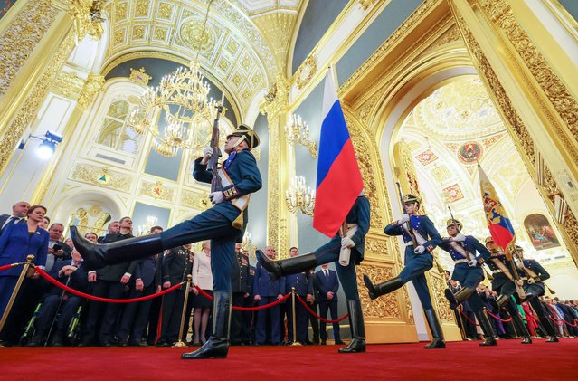Honour guards of the Presidential regiment carry Russian national flag during a ceremony inaugurating Vladimir Putin as President of Russia at the Kremlin in Moscow, Russia on May 7, 2024. (Photo by Alexander Kazakov/Sputnik/Pool via Reuters)
