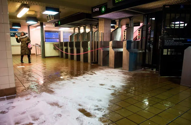 A woman arrives at a closed subway station that services an above ground train in the Bronx Borough March 14, 2017 in New York. (Photo by Don Emmert/AFP Photo)