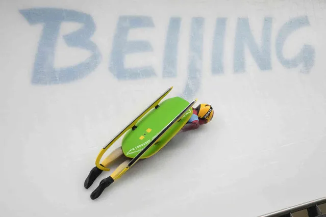 Julia Taubitz, of Germany, crashes during the luge women's singles run 2 at the 2022 Winter Olympics, Monday, February 7, 2022, in the Yanqing district of Beijing. (Photo by Dmitri Lovetsky/AP Photo)