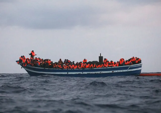 Over 400 migrants are seen overcrowding a wooden vessel drifting in central Mediterranean Sea off the Libyan coast, March 29, 2017 during a search and rescue operation by Spanish NGO Proactiva Open Arms. (Photo by Yannis Behrakis/Reuters)