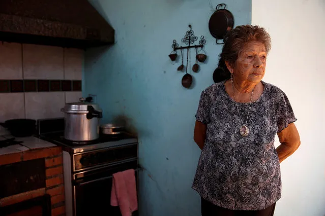 Arcelia Leandro poses for a picture at the kitchen of her house, while she waits for the power to return, during a power cut in Puerto Ordaz in Bolivar state, Venezuela, April 12, 2016. (Photo by Carlos Garcia Rawlins/Reuters)