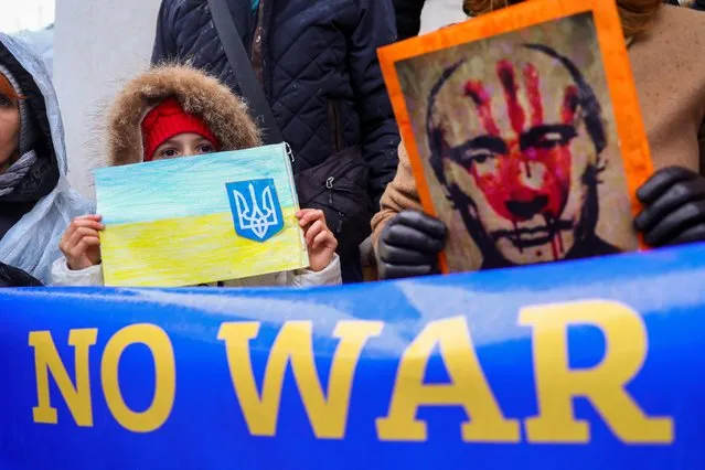 A girl holds a drawing as anti-war demonstrators protest near the Museum of Modern Art and the Russian Embassy, after Russia launched a massive military operation against Ukraine, in Ljubljana, Slovenia, February 25. 2022. (Photo by Borut Zivulovic/Reuters)