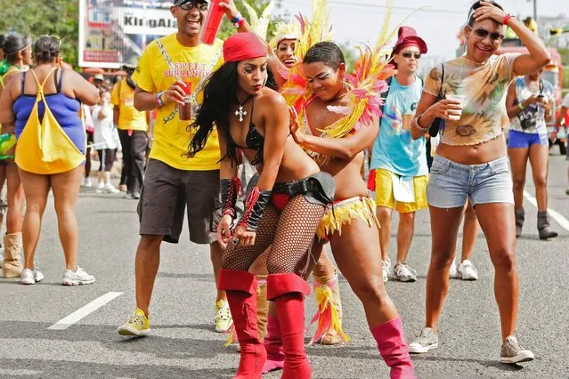 Revelers perform the “wining” dance on a street during the Jamaica Carnival Roadmarch in Kingston, on April 27, 2014. (Photo by Gilbert Bellamy/Reuters)