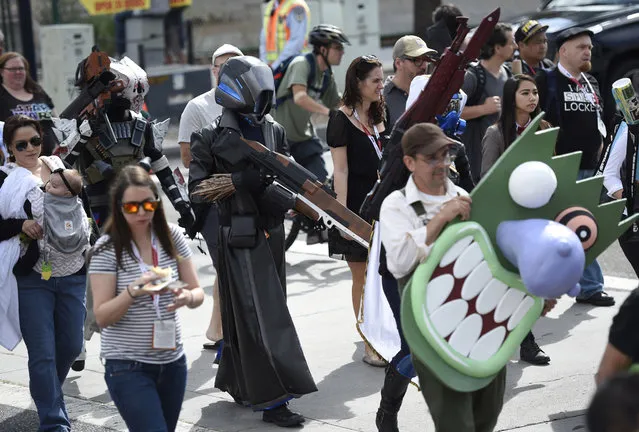 Fans arrive to day 1 of Comic-Con International on Thursday, July 9, 2015, in San Diego, Calif. The pop-culture event runs July 9-12. (Photo by Chris Pizzello/Invision/AP Photo)