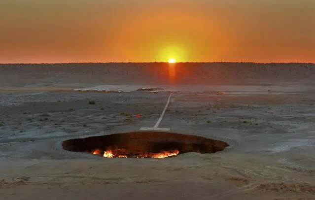 The crater fire named “Gates of Hell” is seen near Darvaza, Turkmenistan, Sunday, July 12, 2020. The president of Turkmenistan is calling for an end to one of the country's most notable but infernal sights – the blazing desert natural gas crater widely referred to as the “Gates of Hell”. The crater, about 260 kilometers (160 miles) north of the capital Ashgabat, has been on fire for decades and is a popular sight for the small number of tourists who come to Turkmenistan, which is difficult to enter. (Photo by Alexander Vershinin/AP Photo)