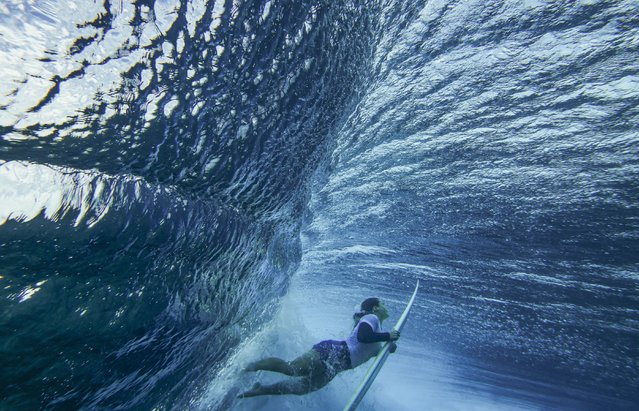 Brisa Hennessy, of Costa Rica, duck-dives a wave in the women's surfing bronze medal final of the surfing competition at the 2024 Summer Olympics, Monday, August 5, 2024, in Teahupo'o, Tahiti. (Photo by Ben Thouard/Pool Photo via AP Photo)