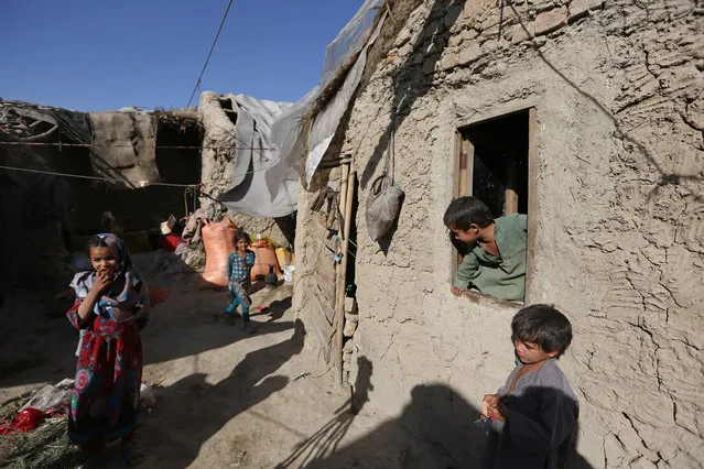In this Monday, May 30, 2016 photo, Afghan children play at their temporary home in a camp for internally displaced people in Kabul, Afghanistan. (Photo by Rahmat Gul/AP Photo)