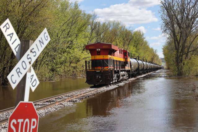 A train travels  along tracks surrounded by floodwater from the Mississippi River on May 01, 2023 near Bellevue, Iowa. Although the Mississippi River crested in the area on Saturday, according to the National Weather Service, the River at Bellevue is not expected to drop below major flood stage until next weekend. (Photo by Scott Olson/Getty Images)