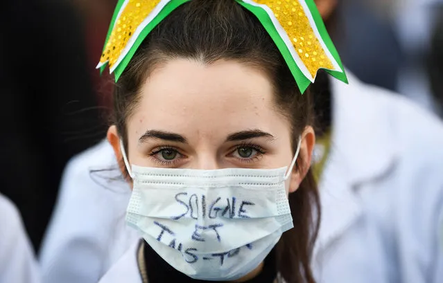 A medicine student of the cheerleader group Bob' Atomic takes part in a march from Lariboisiere hospital to Place de la Republique in Paris on December 17, 2019 to protest in favour of public hospital in order to demand more resources for the hospital as part of a third countrywide day of multi-sector protests over a government pensions overhaul, with the government showing no signs it will give in to union demands to drop the plan. Unions have been striking since December 5 in their biggest show of strength in years against plans for a single pensions system. (Photo by Alain Jocard/AFP Photo)