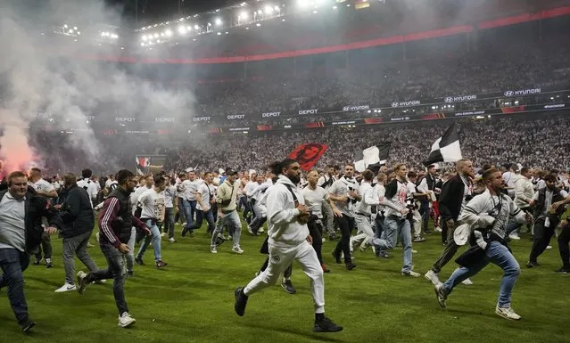 Eintracht Frankfurt fans celebrate on the pitch after the UEFA Europa League semi final, second leg soccer match between Eintracht Frankfu​rt and West Ham United in Frankfurt am Main, Germany, 05 May 2022. (Photo by Ronald Wittek/EPA/EFE)
