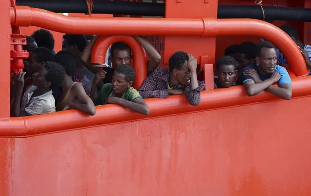 Migrants wait to disembark from  a merchant ship in the Sicilian harbour of Pozzallo, Italy August 2, 2015. Italy's coast guard said about 1,800 migrants were rescued from seven overcrowded vessels on Saturday, while five corpses were found on a large rubber boat carrying 212 others. (Photo by Antonio Parrinello/Reuters)